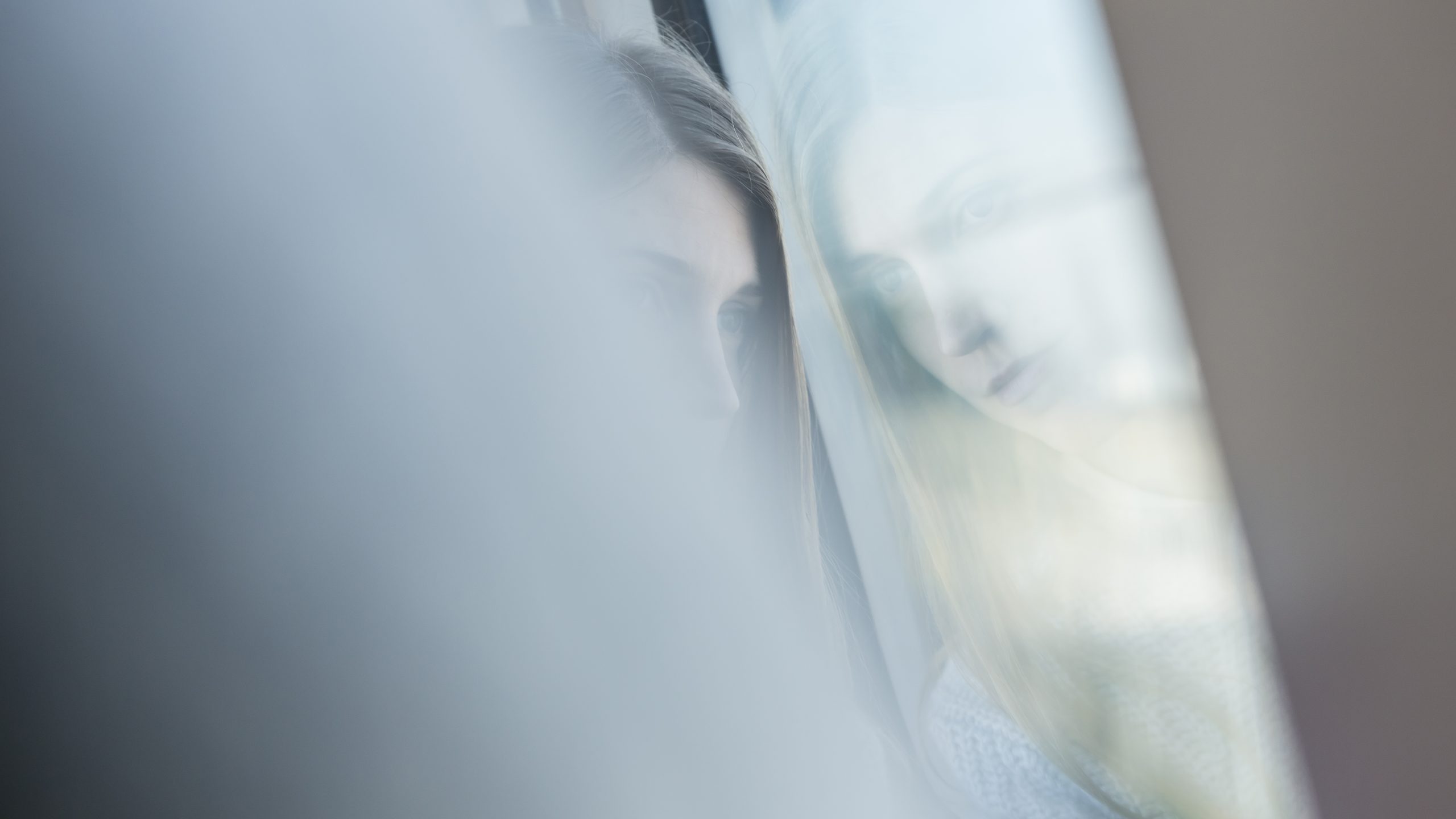 Decorative photograph of a young woman looking out of the window in Hong Kong MTR train - photo by photographer Tuomas Harjumaaskola, China