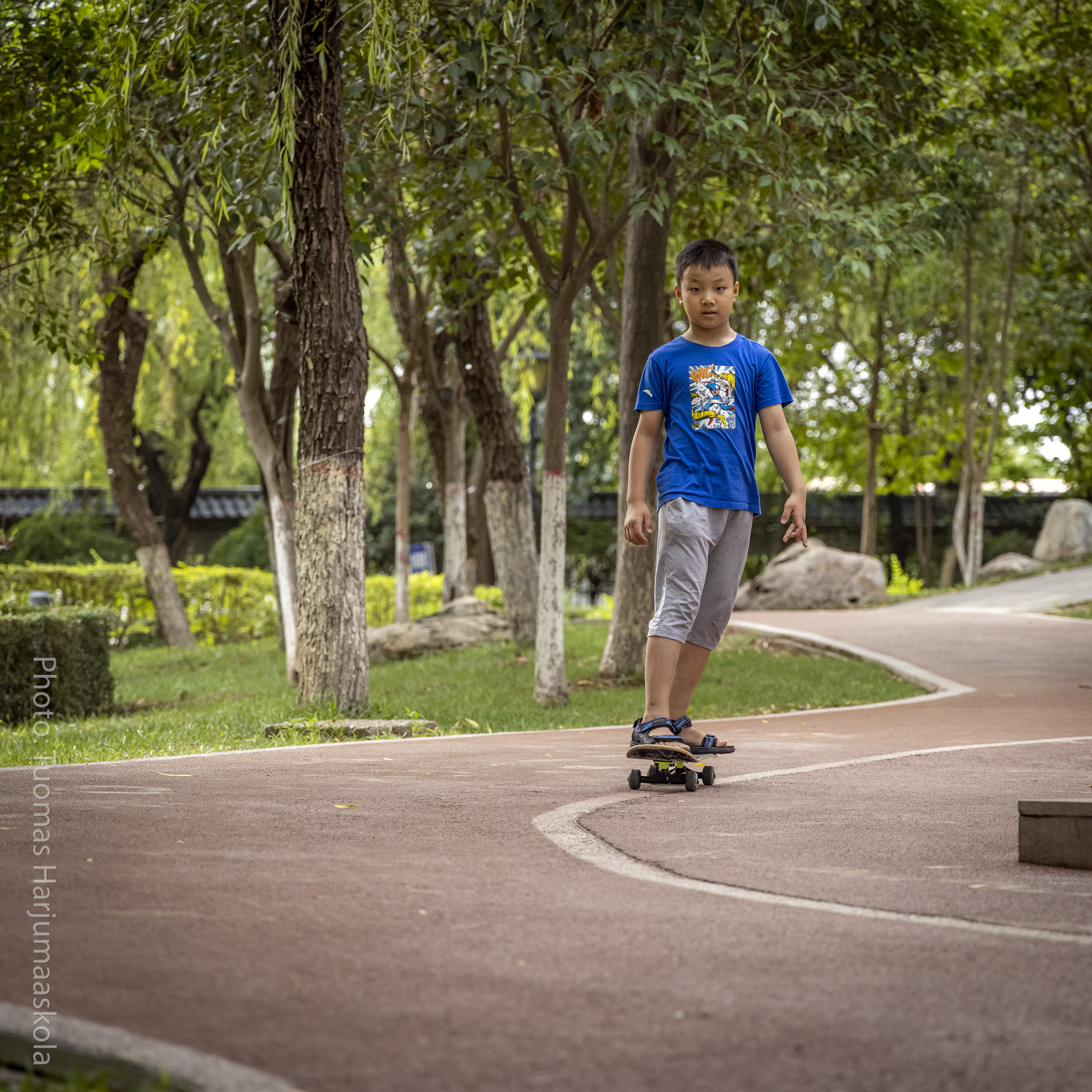 Chinese boy skateboarding. Photographer Tuomas Harjumaaskola.