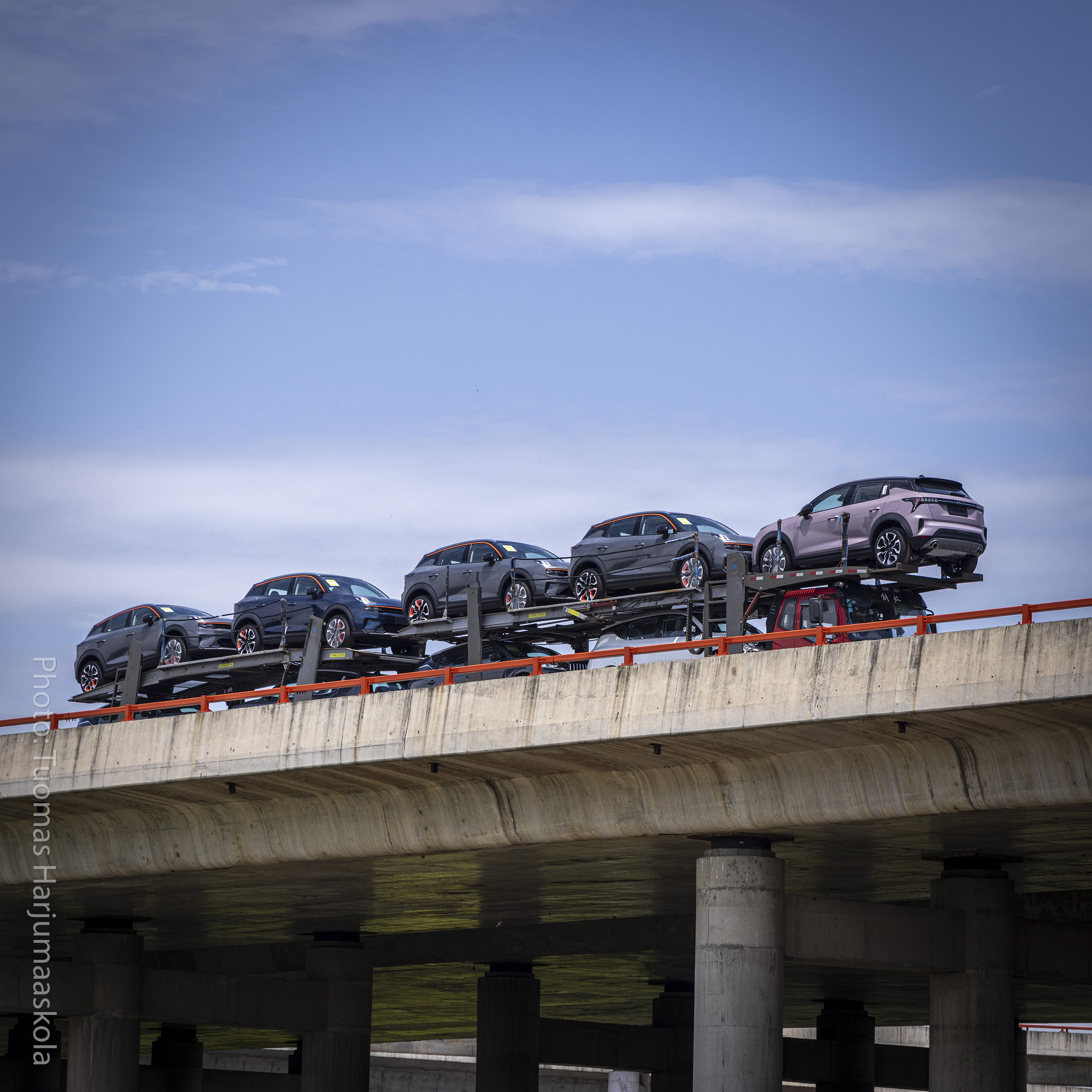 Car carrier trailer, auto transport, on an elevated Chinese highway. Photographer Tuomas Harjumaaskola.